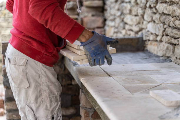 istock DIY home improvement. Man building stone barbeque. 1739697952