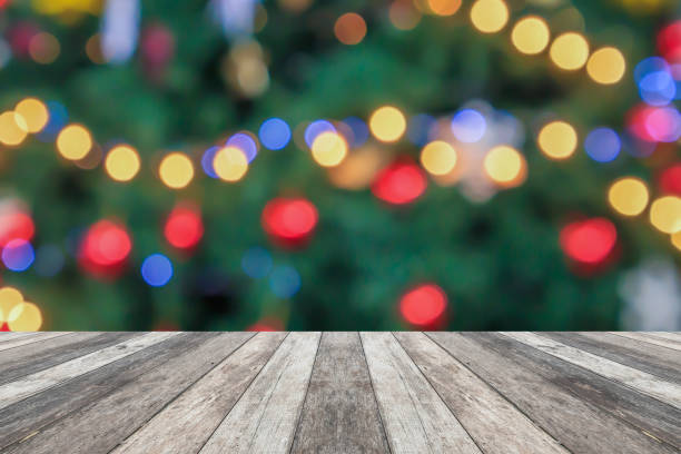 istock Empty wood table top with blur Christmas tree with bokeh light background 1739710163