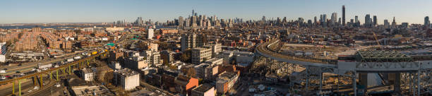 istock Brooklin panoramic view with Elevated Highway-BQE, with traffic on it, train station, and Elevated Subway. Distant view of Manhattan and Jersey City, New Jersey, over Cobble Hill and Carroll Gardens residential districts. Extra-large stitched panorama. 1739719927