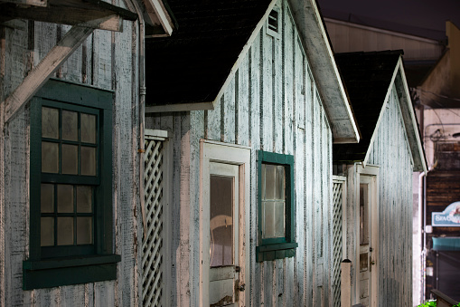 Monterey, California, USA - December 31, 2022: Night time view of the historic Worker's Shacks on Cannery Row.