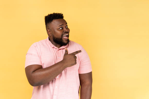 istock Man looking and pointing aside, showing blank copy space for idea presentation, advertisement. 1739722558