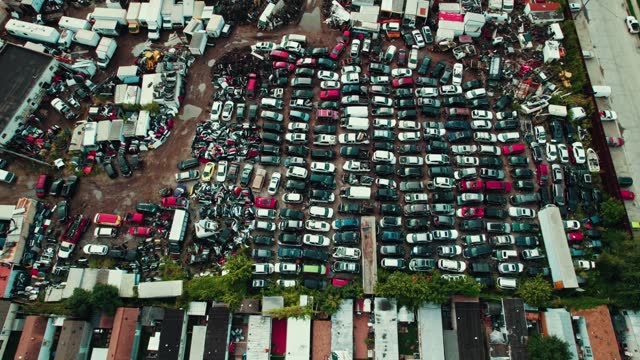 top down Pick and pull  scrap auto yard in Melrose Park, Illinois USA.  You come and pull parts then pay. Junk wrecked auto vehicles sorounded by a mobile home park. 4k Aerial