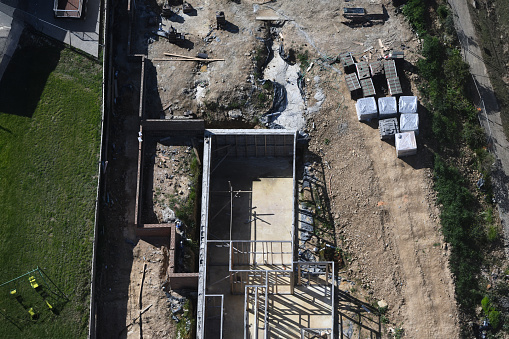 Aerial view of a construction site in progress, showcasing various construction materials and ongoing activities.