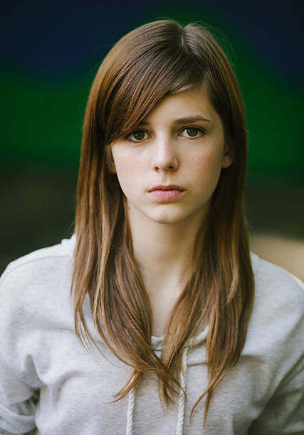 serious caucasian teenager portrait, staring at camera