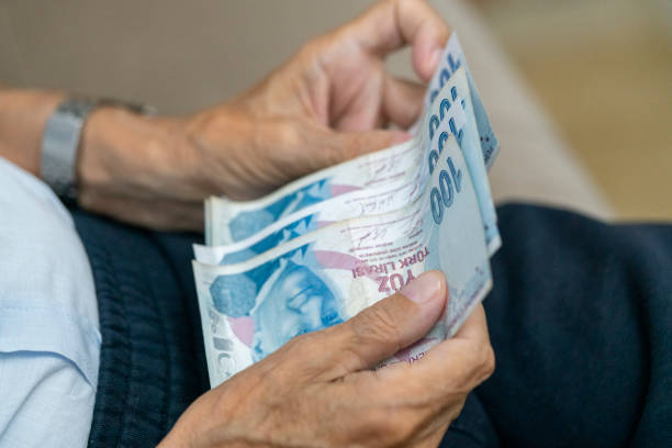 istock Hands holding and counting Turkish money 1739828590