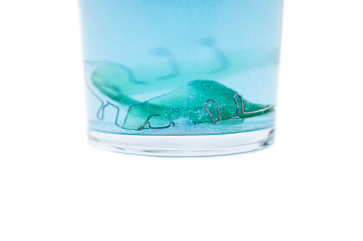 Turquoise transparent glass of water isolated