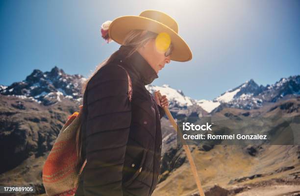 Traveler Hipster Girl In Hat With Backpack Exploring Misty Sunny Mountains In Clouds Space For Text Stock Photo - Download Image Now