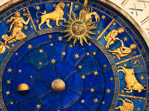top rigth part face of the famous venetian clock -  Torre dell'Orologio on St Mark's Square (Piazza San Marco), showing the some signs of the zodiac (virgo, leo, cancer, gemini, taurus)