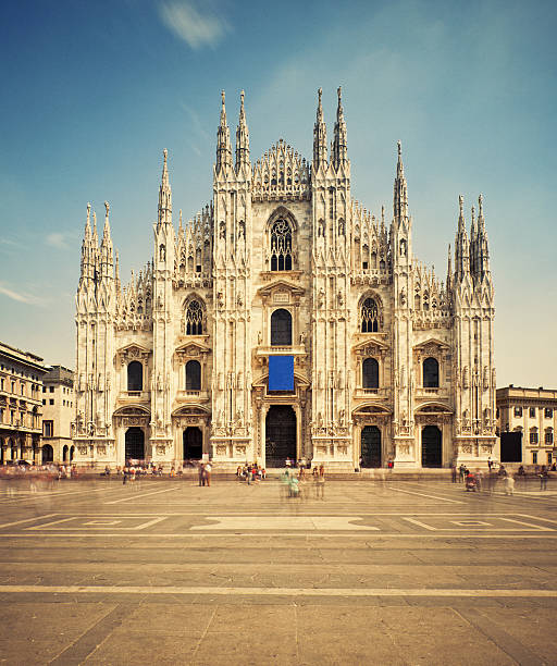 Milan Cathedral and Piazza del Duomo, people in blur motion passing by.