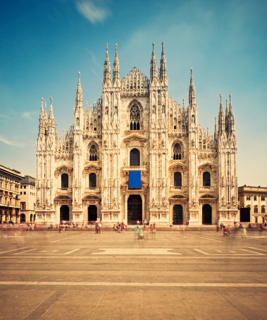 Milan Cathedral and Piazza del Duomo, people in blur motion passing by.