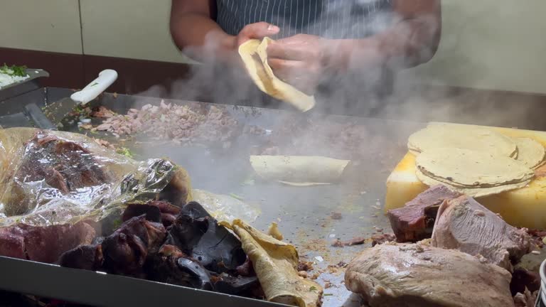 Taquero preparing meat tacos