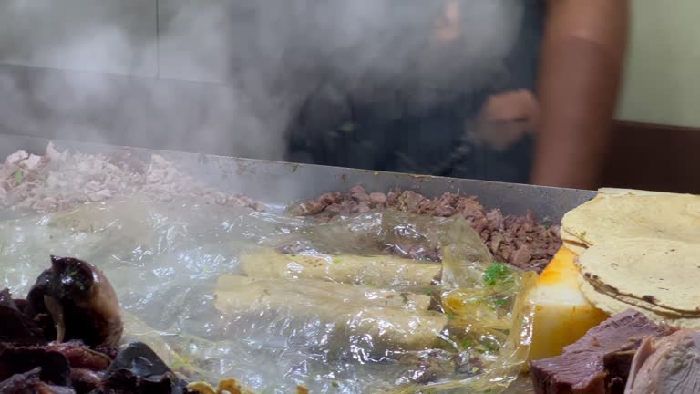 Taquero preparing meat tacos