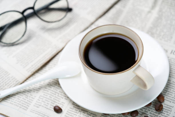 istock Black coffee and coffee beans on newspaper 1739966702