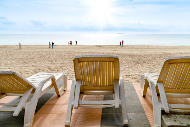 istock White beach chair on tropical beach with blue sky 1739990794