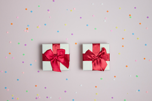 Gift boxes over the colorful dot over the pink background.