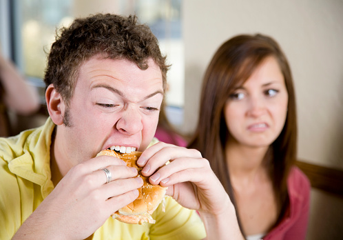 A young couple in a fast food restaurant.