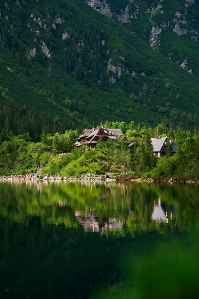 View on cabin in mountains with green forest. House for tourists in Tatra National Park near Morskie Oko or Eye Sea lake. Touristic place in Poland