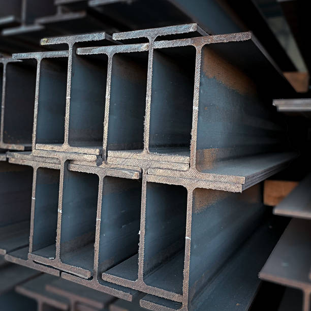 istock Steel beams production. Metal girders stack on project construction , steel h-beam, selective focus, Raw materials used in building construction. 1740068762