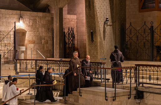 Nazareth, Israel, September 17, 2023 : The monks after finishing prayer leave main altar of the Church of the Annunciation in the Nazareth city in northern Israel