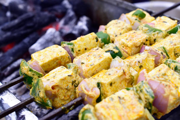 istock Closeup of marinated paneer tikka at barbeque 1740100317