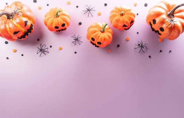 istock Halloween decorations made from pumpkin, paper bats, black spider on pastel background 1740104192