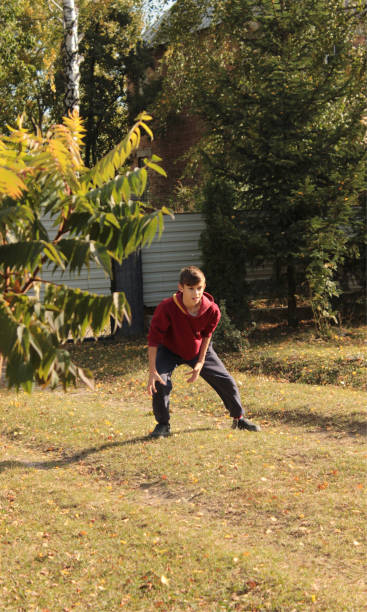 istock the boy got into a pose catching the ball 1740105864