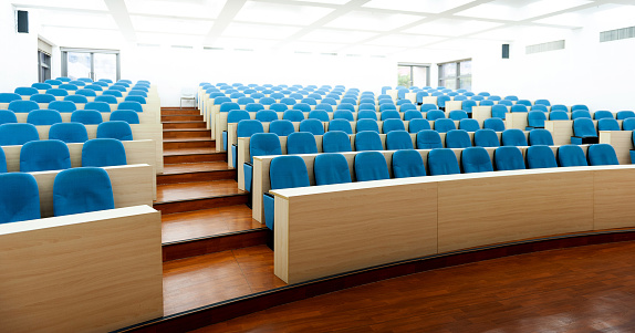 Empty college lecture hall with row of chairs