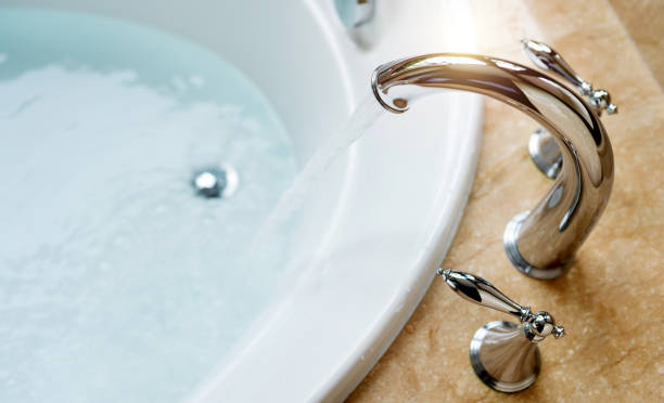 istock Luxury bath tub and water tap with flowing water 1740125465