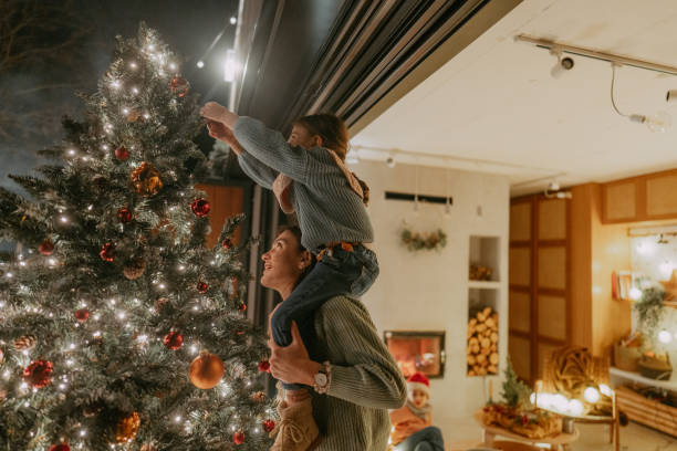 istock Decorating our Christmas tree outdoors 1740133649