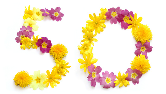 fifty 50 number made from freshly picked yellow and pink flowers. for birthday party, anniversaries, wedding celebrations and corporate events, isolated on a white background