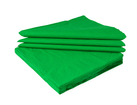 Green paper napkins on white background close up photo