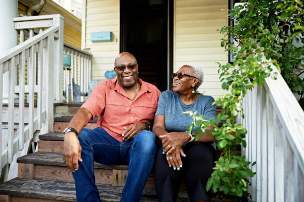 istock Summer portrait of retired couple relaxing on front steps 1740176764