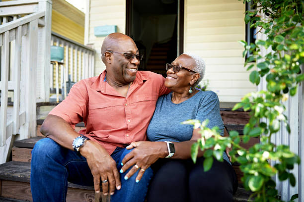 Senior Black couple relaxing on front steps