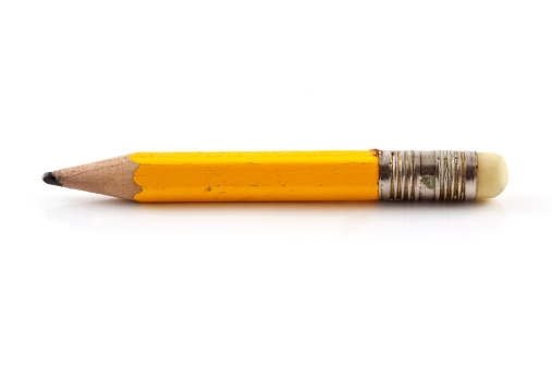 School supplies.  Wooden pencil with metal sharpener and checkered notebook
