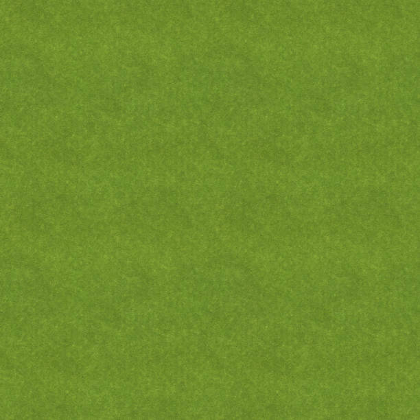 Seamless felt texture background - high quality file - textile product in green color with visible little fibers - raw uneven messy recycled paper structure in macro - grass texture pattern