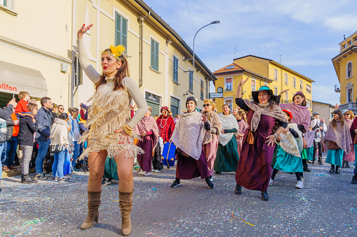 Cantu, Italy - February 25, 2023: Carnival parade, dancers group, and crowd, in Cantu, Lombardy, Northern Italy