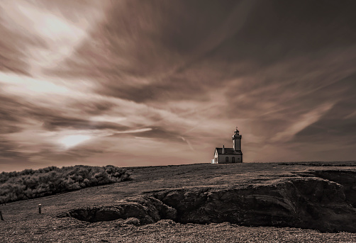 The Pointe du Poulains on the island of Belle-île-en-Mer and its famous lighthouse. Here, landscape in infrared and sepia.