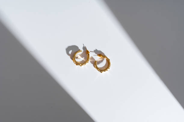 istock Golden earrings on white background studio shot 1740221540