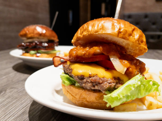 istock cheese hamburger. A dish with bacon, cheese, patty, and salsa sauce sandwiched between buns. 1740222133
