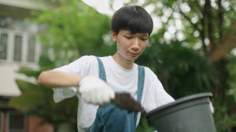 Asian man preparing soil for gardening