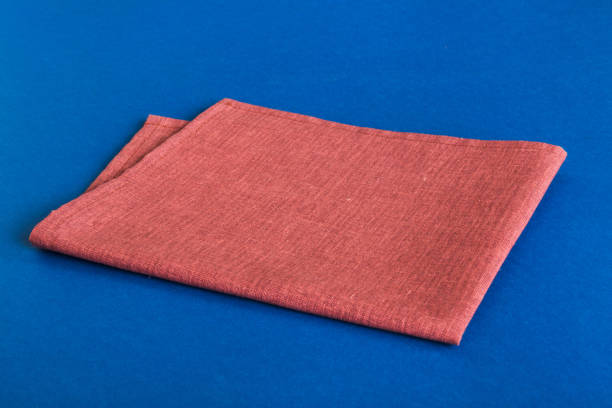 istock top view with red empty kitchen napkin isolated on table background. Folded cloth for mockup with copy space, Flat lay. Minimal style 1740229043