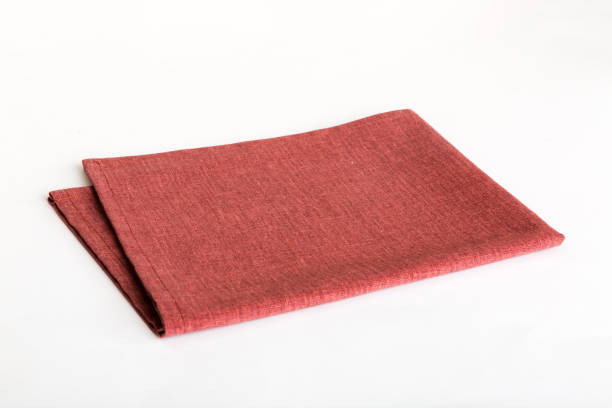 istock top view with red empty kitchen napkin isolated on table background. Folded cloth for mockup with copy space, Flat lay. Minimal style 1740229050