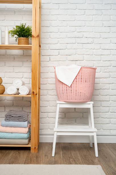 istock Pink plastic laundry basket in a bathroom 1740230690