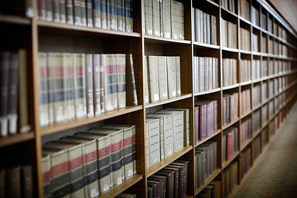 Endless Books On Shelves At The Library A seemingly endless row of  text books and shelves.  VERY shallow depth of field.  Horizontal with copy space. encyclopaedia stock pictures, royalty-free photos & images