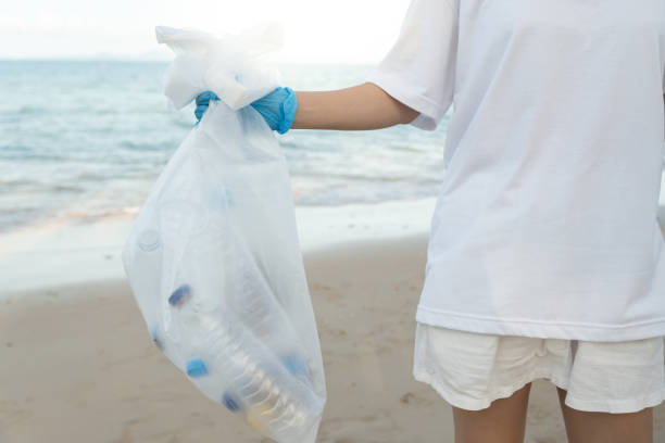 istock Save ocean. Volunteer pick up trash garbage at the beach and plastic bottles are difficult decompose prevent harm aquatic life. Earth, Environment, Greening planet, reduce global warming, Save world 1740248304