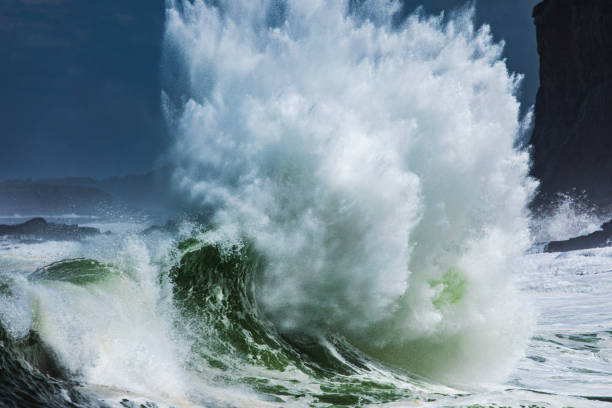 istock Close up of powerful backwash wave exploding from surging storm swell colliding with the coast in high contrast light 1740252525
