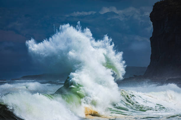 istock Close up of powerful backwash wave exploding from surging storm swell colliding with the coast in high contrast light 1740252540