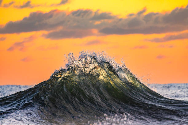 istock Silhouette backwash waves colliding in warm morning light 1740253630