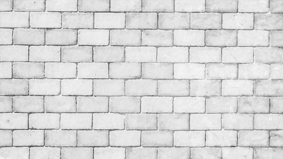 A very light grey white colored brick wall with rectangular blocks, textured grungy vector backgrounds. There is no people and copy space. It is a rustic modern backdrop template.