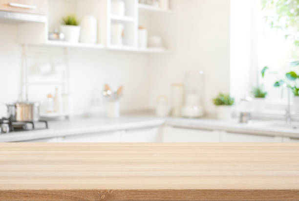 istock Wooden table top view for product montage over blurred kitchen interior background 1740262516